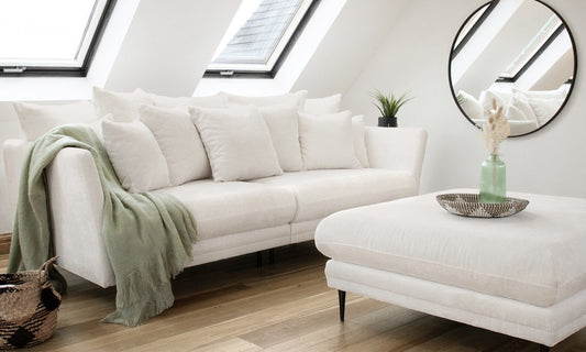 light colored sofa with footstool