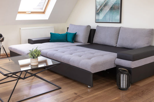 grey and black coloured sofa bed with a nice coffee table in front