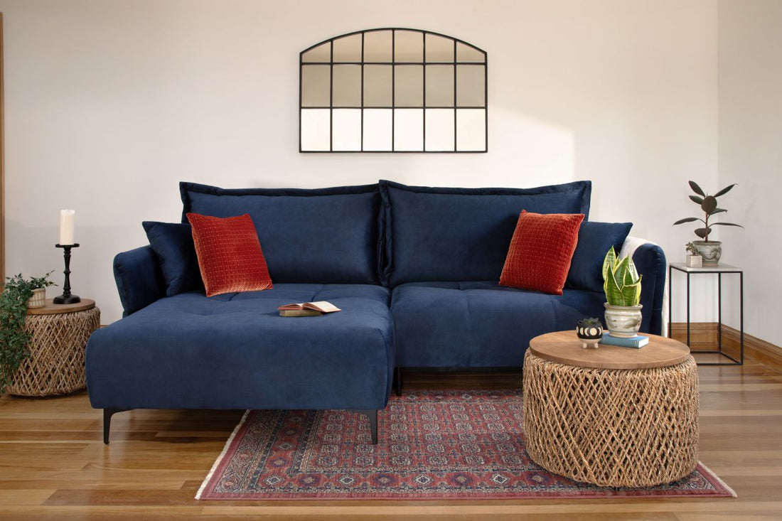 blue sofa bed with pillows and small coffee table