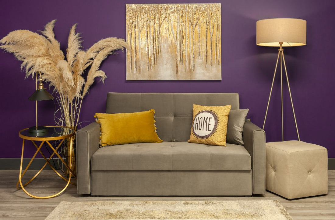 plush grey sofa with violet painted wall at the back