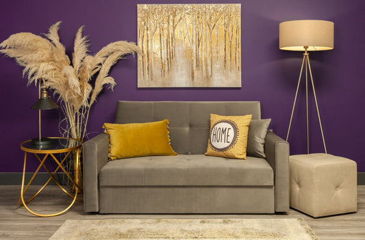 plush grey sofa with violet painted wall at the back