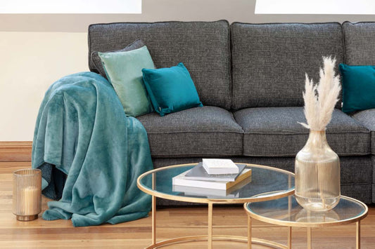 grey fabric sofa with blue pillows and blankets