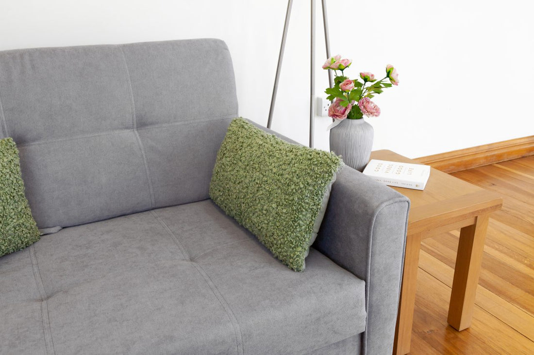 grey sofa bed with a coffee table at the side